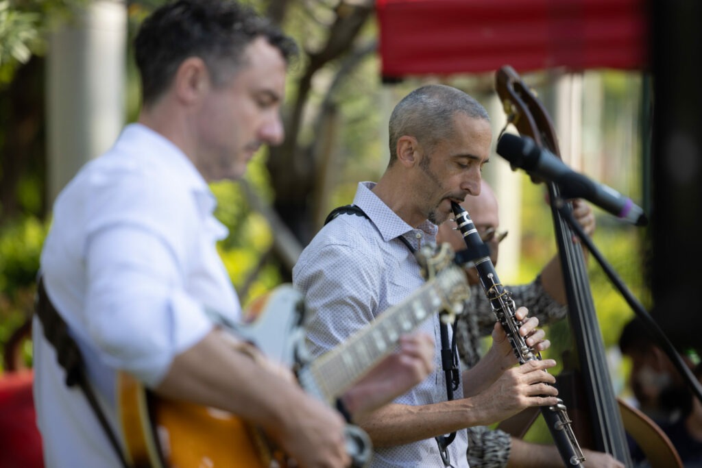 Two men playing guitar and clarinet at jazz concert